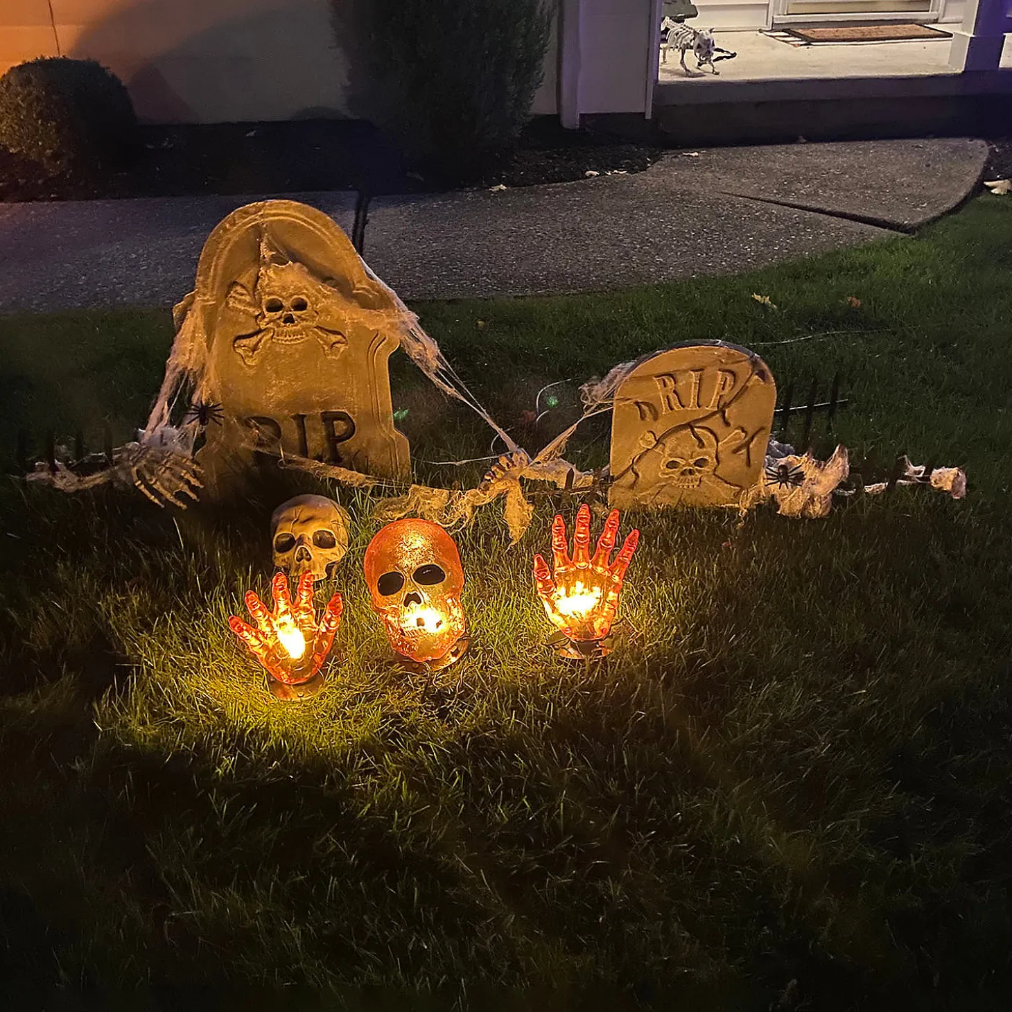 8.5" Lighted Orange Skull And Hands Outdoor Halloween Decoration - 4Ft Black Wire